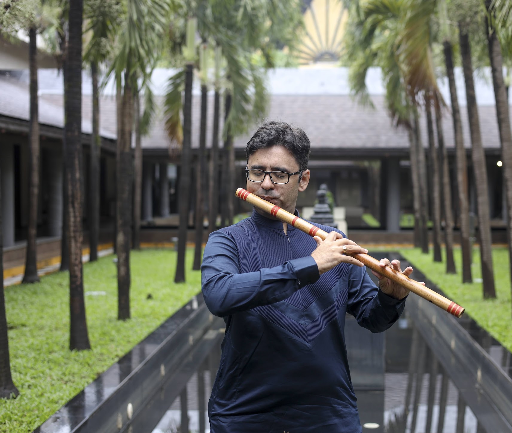 Harsh Dave performing on the bansuri in a courtyard
